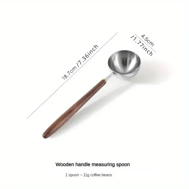 Stainless steel 25ml coffee scoop with wooden handle for precision measurements.