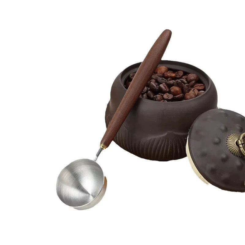 Stainless steel 25ml coffee scoop with wooden handle in the main product version.