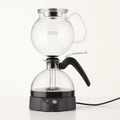 Bodum ePebo electric vacuum coffee maker centered upright on bright white with soft warm studio lighting and a subtle shadow