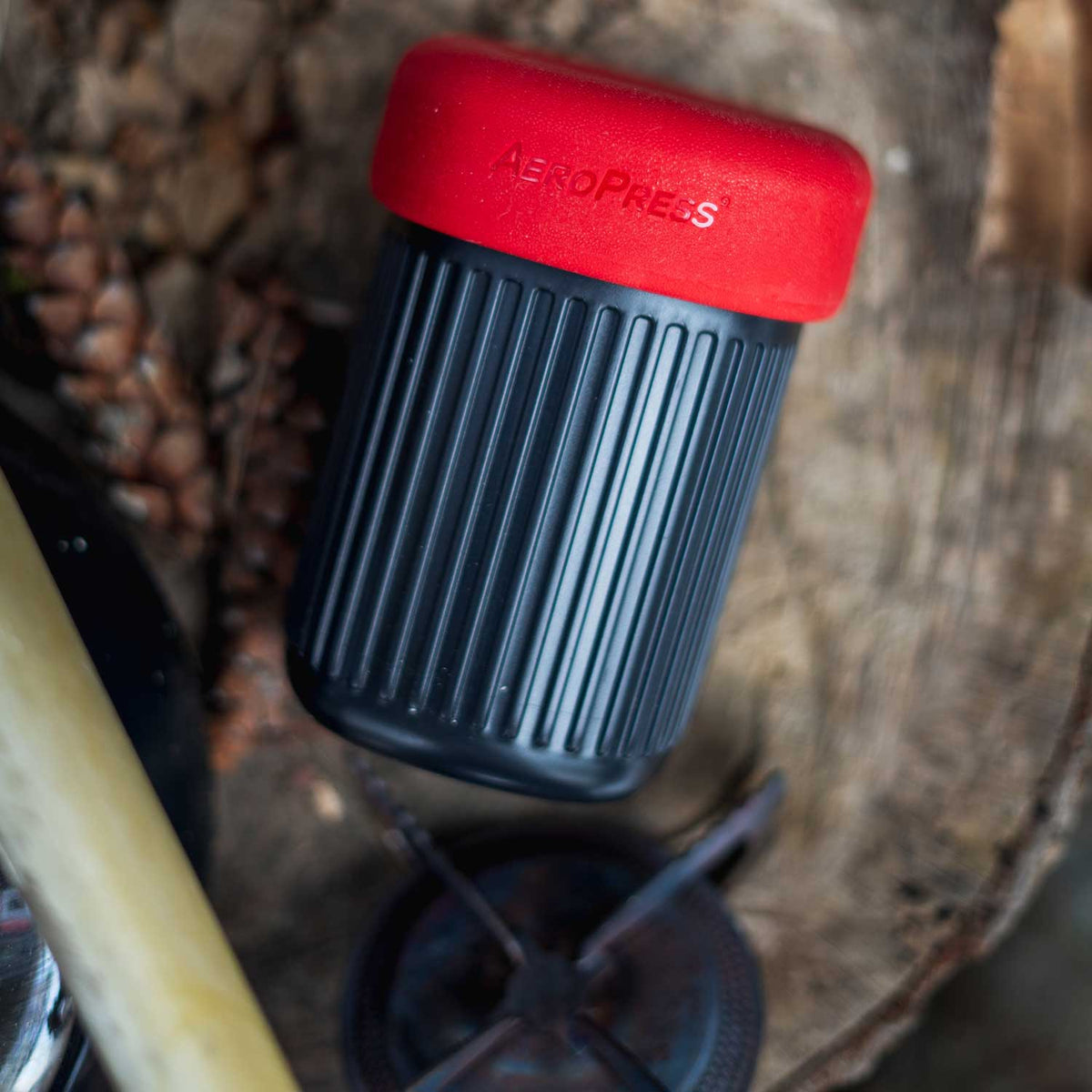 AeroPress Go Travel Coffee Maker in black with mug and lid.