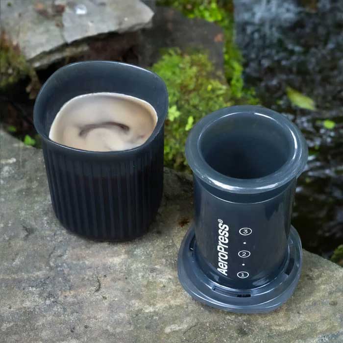 Espresso Parts AeroPress Go Travel Coffee Maker in black with mug and lid.
