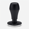 Normcore tamper on a bright white background with soft warm studio lighting and a subtle shadow