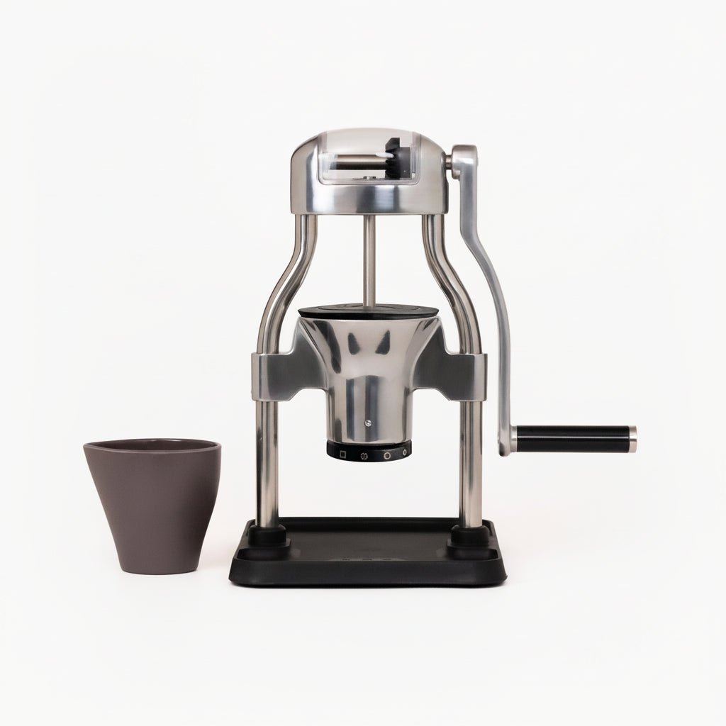 ROK GrinderGC PLUS hand grinder with polished aluminum arms on a black base, with its grounds cup