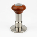 Wooden-handle espresso tamper centered on white with soft studio lighting and a subtle shadow